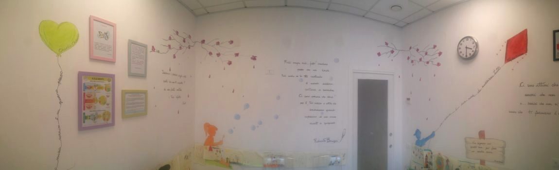 La sala d’attesa dipinta, con il palloncino a cuore, la bambina con le bolle e l’aquilone